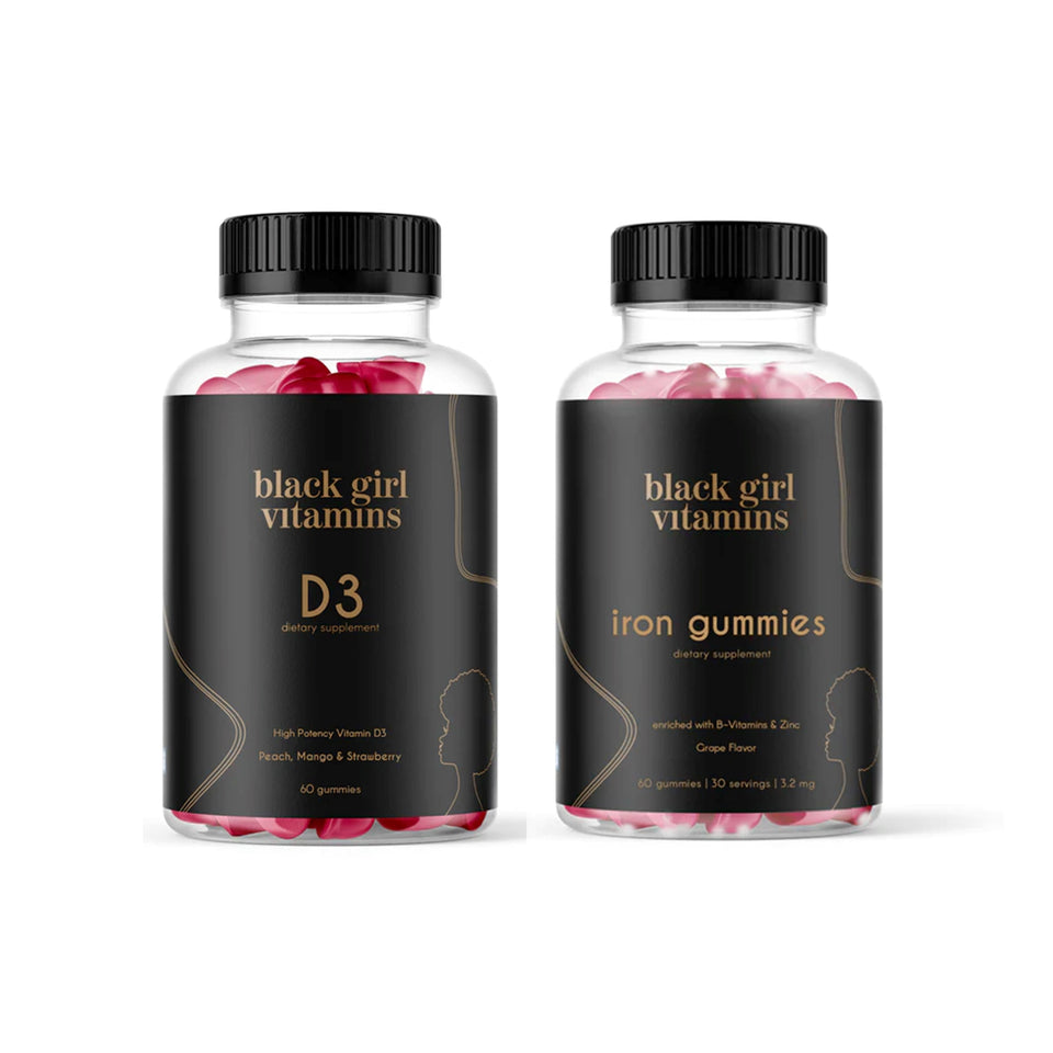 Two bottles of Black Girl Vitamins dietary supplements: one labeled 'D3' with peach, mango & strawberry flavor, 60 gummies; the other labeled 'iron gummies' with grape flavor, 60 gummies, 30 servings, 3.2 mg.